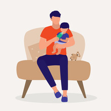 Father Sitting On A Sofa Chair While Bottle Feeding His Baby.