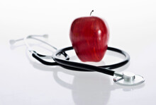Red Apple And Stethoscope Isolated On White Background