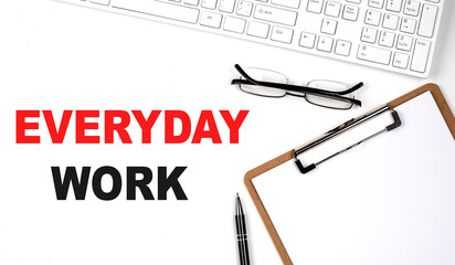 Poster - EVERYDAY WORK text written on the white background with keyboard, paper sheet and pen