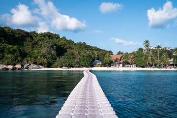 Wall Mural - floating bridge to beautiful beach. clear blue water