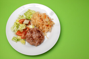 Sticker - grilled hamburger with salad and salted salas cabbage with carrot on white plate