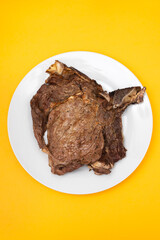 Wall Mural - grilled fresh meat on big gray dish on yellow