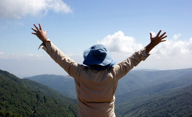 man opening his arms towards the sky