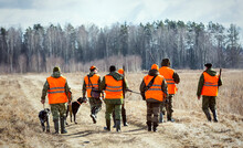 Hunters With Dogs Go To The Forest During The Hunting Season