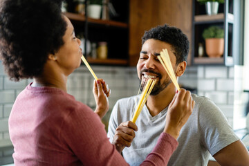 Wall Mural - Happy couple having breakfast together in the kitchen