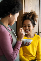 Wall Mural - Happy mother and children in the kitchen. Healthy food, family, cooking concept