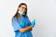 Lithuanian Woman Dentist Holding Tools Over Isolated Background Pointing Back