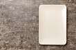 Top view of empty square plate on cement background. Empty space for your design