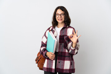 Teenager Ukrainian student isolated on white background showing ok sign with fingers