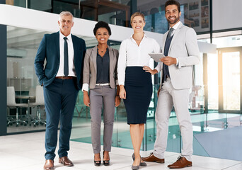 Wall Mural - We always bring our A-game. Portrait of a group of businesspeople standing together in an office.