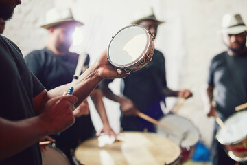 Wall Mural - These are the beats of Brazil. Closeup shot of a musical performer playing drums with his band.