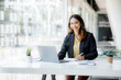 © David - Shot of Asian young business woman working on laptop computer in her workstation.Portrait of Business people employee freelance online marketing e-commerce telemarketing concept.