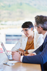 Aufkleber - Sharing ideas for the betterment of business. Shot of two colleagues working on a laptop at a desk in an office.