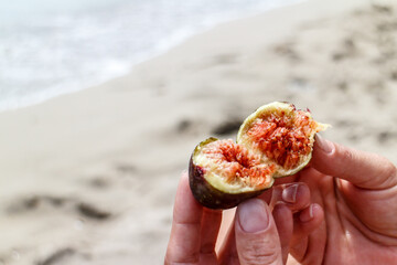 Person breaking open a ripe succulent fig