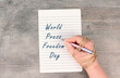World Press Freedom Day is standing on a paper, hand with pen is chained, free speech, cancel culture, journalist writing
