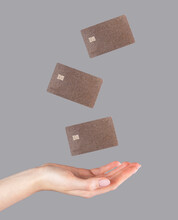 Woman Hand And Levitating Plastic Debit Cards. Online Shopping, Booking, Performing Bank Transactions Concept. High Quality Photo