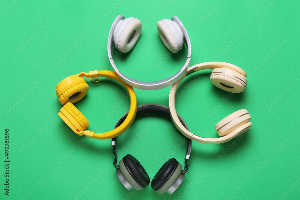 Different headphones on green background