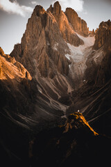 Wall Mural - Landscape view of the Dolomites mountains under a cloudy sky during the sunrise