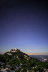 Wall Mural - vertical shot of starry night sky from a mountainous landscape
