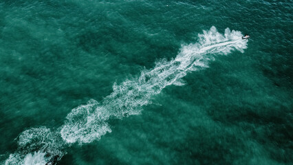 Wall Mural - Aerial view of a speeding boat in the sea