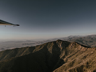 Sticker - Aerial view of the beautiful mountains seen through a helicopter in flight