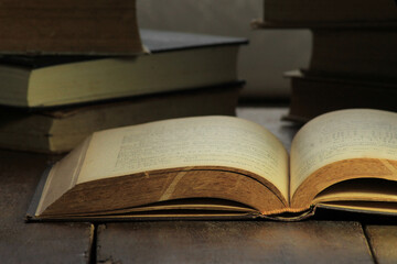 Poster - Closeup of an old book on a wooden table