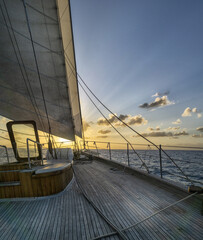 Wall Mural - Vertical shot of the beautiful sunset. View from the sailing ship.