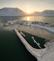 Poster - Vertical aerial view of the port and the lake covered with snow and surrounded by mountains