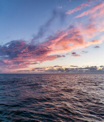 Wall Mural - Vertical shot of the beautiful sunset above the sea.