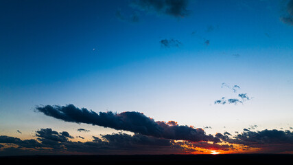 Poster - Mesmerizing scene of a large colorful sky with gray clouds at sunset sky