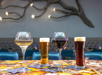 Wall Mural - Closeup of glasses of beer on a table in a restaurant