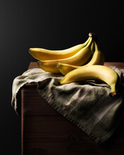 Vertical Still Life Of Bananas On A Black Background