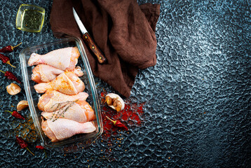 Wall Mural - Raw uncooked chicken legs with ingredients for cooking