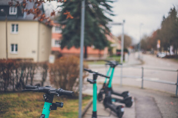 Sticker - Closeup of green electric scooters in the street