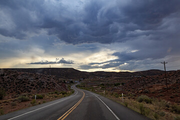 Canvas Print - Spectacular view on a highway of a rocky landscape on cloudy sky background in Arizona, USA