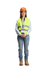 Full length portrait of a young female engineer with a safety vest and hardhat