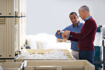 Aufkleber - Stock control is vitally important. Shot of two factory managers doing an inspection of raw materials.