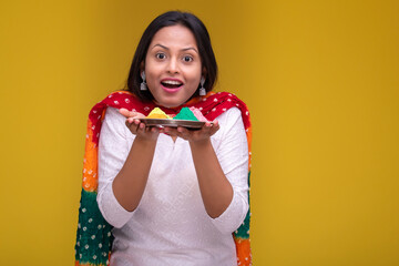 Portraits of young woman celebrating holi