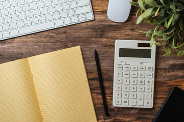 Poster - top view  wood table with calculator and notebook working desk at home
