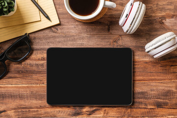 Poster - top view working desk with tablet ,keyboard headphone on wooden table background