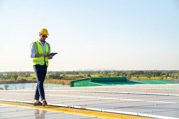 Wall Mural - professional man engineer using tablet maintaining solar cell panels on building rooftop. technician