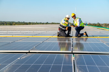 Wall Mural - professional engineer using drone and digital tablet maintaining solar cell panels together on build