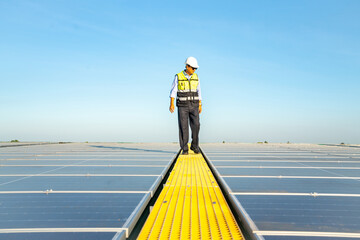 Wall Mural - professional man engineer using tablet maintaining solar cell panels on building rooftop. technician