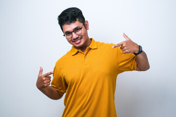 Wall Mural - Young handsome man wearing casual shirt looking confident with smile on face, pointing oneself with fingers proud and happy