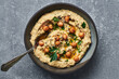 Vegan chickpea hummus with chia seeds and parsley.Traditional vegan chickpea hummus garnished with parsley olive oil and chia seeds. Vegan diet super food. 