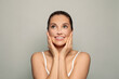 © artmim - Happy woman looking up on white background