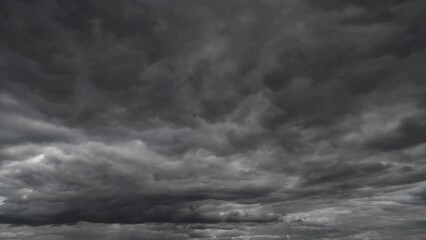 Wall Mural - background of dark dramatic sky with stormy clouds timelapse before rain or snow, extreme weather