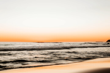 Wall Mural - Beautiful shot of a beach in the background of seascape in the sunset.