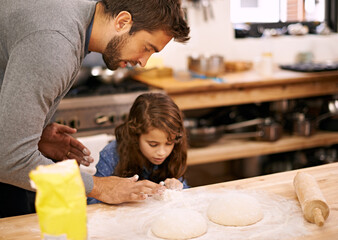 Sticker - Lets make a tiny one too. Shot of a father and daughter working with pizza dough in the kitchen.