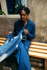 Poster - Young African american male eco fashion deisgner holding his organics product